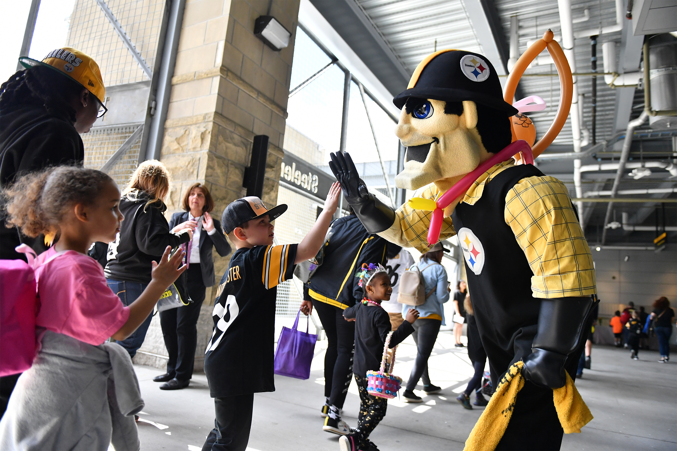 Steelers Mascot Steely McBeam giving a child a high-five